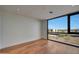 A light-filled bedroom features a large window with views of the outside and hardwood floors at 5000 E Camelback Ridge Rd # 204, Scottsdale, AZ 85251