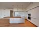 Modern kitchen featuring sleek cabinetry, a large island, pendant lighting, and stainless steel appliances at 5000 E Camelback Ridge Rd # 204, Scottsdale, AZ 85251