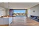 Modern living room featuring hardwood floors, sleek fireplace, and sliding glass doors to the outdoors at 5000 E Camelback Ridge Rd # 204, Scottsdale, AZ 85251