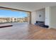 Contemporary living room boasting a cozy fireplace, neutral tones, and a spacious balcony with city views at 5000 E Camelback Ridge Rd # 204, Scottsdale, AZ 85251