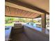 Outdoor kitchen featuring a built-in grill, sink, bar and covered patio, perfect for alfresco entertaining by the pool at 7801 E Davenport Dr, Scottsdale, AZ 85260