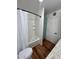 Cozy bathroom with a shower-tub, wooden floors, and a mint green cabinet at 8241 N Central Ave # 24, Phoenix, AZ 85020