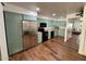 Spacious kitchen featuring stainless steel appliances, wooden floors, and stylish aqua cabinetry at 8241 N Central Ave # 24, Phoenix, AZ 85020