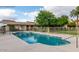 Community pool area surrounded by lush green landscaping with palm trees at 8241 N Central Ave # 24, Phoenix, AZ 85020