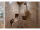 Spa-like bathroom with a large shower and stone tile at 9177 E Sunflower Ct, Scottsdale, AZ 85266