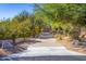 Attractive driveway leading to a beautiful home with desert landscaping at 9177 E Sunflower Ct, Scottsdale, AZ 85266