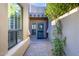 Inviting entryway with a blue metal door and well-manicured plants at 9177 E Sunflower Ct, Scottsdale, AZ 85266