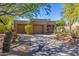 Lovely stucco home with two-car garage and mature trees at 9177 E Sunflower Ct, Scottsdale, AZ 85266