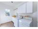 Bright laundry room with washer, dryer, and cabinets at 9177 E Sunflower Ct, Scottsdale, AZ 85266