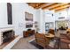 Living room features a fireplace, wood beams, and a comfortable seating arrangement at 9177 E Sunflower Ct, Scottsdale, AZ 85266