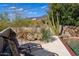 Landscaped pool area with lounge chairs and desert plants at 9177 E Sunflower Ct, Scottsdale, AZ 85266