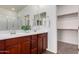 Bathroom featuring a double vanity with framed mirrors and a walk-in closet for ample storage at 10065 E Thatcher Ave, Mesa, AZ 85212