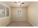 Bedroom featuring a ceiling fan, neutral walls and a window with shutters at 10065 E Thatcher Ave, Mesa, AZ 85212