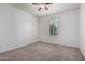 Neutral bedroom with a ceiling fan and plantation shutters allowing natural light at 10065 E Thatcher Ave, Mesa, AZ 85212