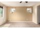 Spacious bedroom with neutral walls, carpet flooring, and three windows at 10065 E Thatcher Ave, Mesa, AZ 85212