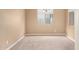 Cozy carpeted bedroom with neutral paint, window, and ample natural light at 10065 E Thatcher Ave, Mesa, AZ 85212