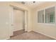 Carpeted bedroom with a ceiling fan and window with louvers at 10065 E Thatcher Ave, Mesa, AZ 85212