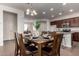 Charming dining room area seamlessly flows into the kitchen with bar seating, promoting a modern and open living at 10065 E Thatcher Ave, Mesa, AZ 85212