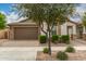 Charming single-story home featuring a two-car garage and manicured landscaping at 10065 E Thatcher Ave, Mesa, AZ 85212