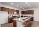 Well-lit kitchen featuring granite countertops, stainless appliances, breakfast bar, and modern cabinetry at 10065 E Thatcher Ave, Mesa, AZ 85212