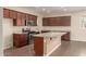 Kitchen features granite countertops, stainless steel appliances, an island with a sink, and dark wood cabinets at 10065 E Thatcher Ave, Mesa, AZ 85212