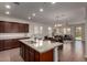 Open kitchen with a granite island, stainless steel appliances, and seamless flow to living areas at 10065 E Thatcher Ave, Mesa, AZ 85212