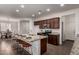 Bright kitchen features a granite island with seating, stainless appliances, and lots of storage at 10065 E Thatcher Ave, Mesa, AZ 85212