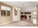 Bright open-concept kitchen featuring dark wood cabinetry, an island with granite countertop, and tile floors at 10065 E Thatcher Ave, Mesa, AZ 85212