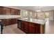 Kitchen features granite countertops, stainless steel appliances, dark wood cabinets, and an island with a sink at 10065 E Thatcher Ave, Mesa, AZ 85212