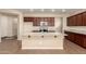 Kitchen features granite countertops, stainless steel appliances, an island, and dark wood cabinets at 10065 E Thatcher Ave, Mesa, AZ 85212