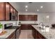 Beautiful kitchen with granite countertops, stainless steel appliances, and a convenient breakfast bar at 10065 E Thatcher Ave, Mesa, AZ 85212