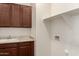 Laundry room features sink, cabinets, and hookups for a washer and dryer at 10065 E Thatcher Ave, Mesa, AZ 85212