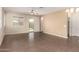 Spacious living area featuring tile floors, neutral paint, and slider door access to backyard at 10065 E Thatcher Ave, Mesa, AZ 85212