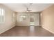 Well-lit open living area with neutral paint, tile floor, and backyard access at 10065 E Thatcher Ave, Mesa, AZ 85212