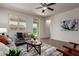 Airy living room featuring a ceiling fan, large windows, neutral paint, and contemporary decor at 10065 E Thatcher Ave, Mesa, AZ 85212