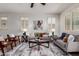 Open living room with ample seating, stylish decor, ceiling fan, and abundant natural light at 10065 E Thatcher Ave, Mesa, AZ 85212