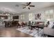 Spacious living room flows into dining area, showcasing modern furnishings and lots of light at 10065 E Thatcher Ave, Mesa, AZ 85212