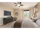 Bright main bedroom features a ceiling fan, and a large window at 10065 E Thatcher Ave, Mesa, AZ 85212