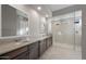 Modern bathroom with double vanity and large glass shower at 22531 E Orchard Ln, Queen Creek, AZ 85142