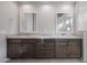 Double vanity with dark brown cabinets and granite countertop at 22531 E Orchard Ln, Queen Creek, AZ 85142