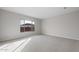 Spacious bedroom with large window and carpeted floor at 22531 E Orchard Ln, Queen Creek, AZ 85142