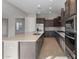 Open concept kitchen with dark cabinetry and an island at 22531 E Orchard Ln, Queen Creek, AZ 85142