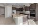 Modern kitchen with island, stainless steel appliances, and dark cabinets at 22531 E Orchard Ln, Queen Creek, AZ 85142