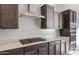 Stainless steel range hood over gas cooktop with dark cabinetry at 22531 E Orchard Ln, Queen Creek, AZ 85142
