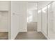 Bathroom with glass shower, tile floor, walk-in closet, and view into bedroom at 24592 W Bowker St, Buckeye, AZ 85326