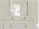 Bright bathroom featuring a double sink vanity with a large mirror at 24592 W Bowker St, Buckeye, AZ 85326