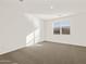 Bright bedroom with neutral carpet, a window, and plenty of natural light at 24592 W Bowker St, Buckeye, AZ 85326