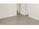 Hallway with light tile flooring, white walls, and multiple doorways leading to other rooms at 24592 W Bowker St, Buckeye, AZ 85326