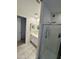Bright bathroom featuring a tiled shower with glass doors and white vanity at 5636 W Jackalope Ln, Laveen, AZ 85339