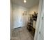 Clean entryway featuring tile flooring, a white door, and a decorative shelf with various decorations at 5636 W Jackalope Ln, Laveen, AZ 85339